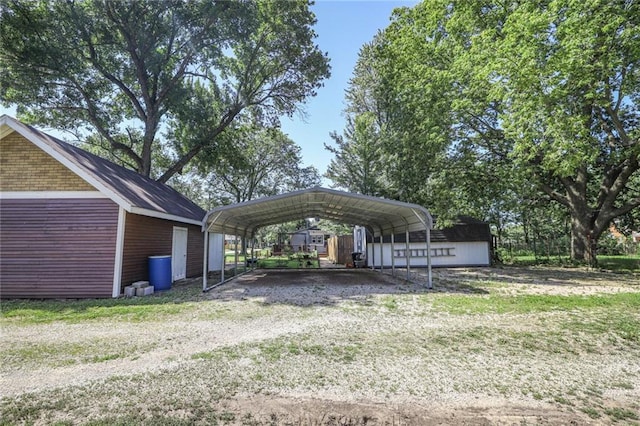 311 E Mary St, Yates Center, KS 66783 - view of property's community with a shed, a detached carport, and a yard