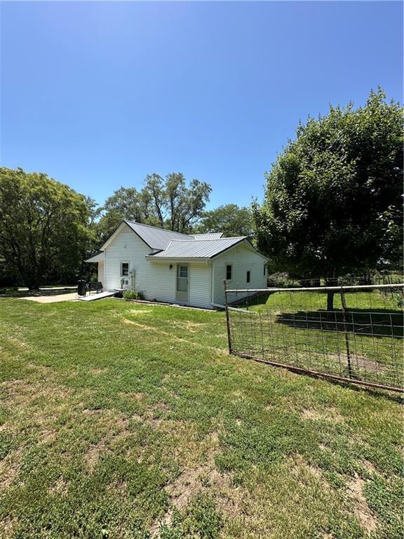 317 Chrissenger St, Burlington Junction, MO 64428 - view of side of home with a metal roof