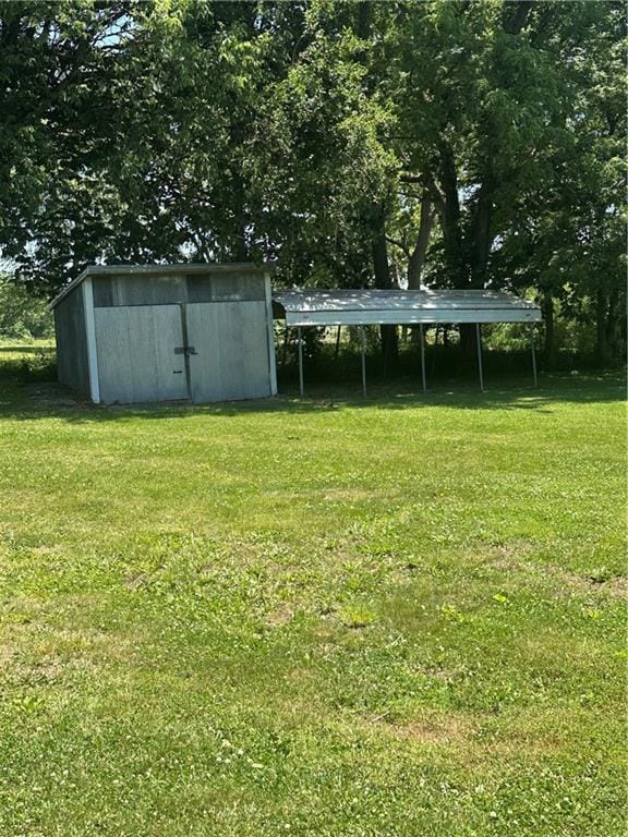 317 Chrissenger St, Burlington Junction, MO 64428 - view of grassy yard with a carport and a shed