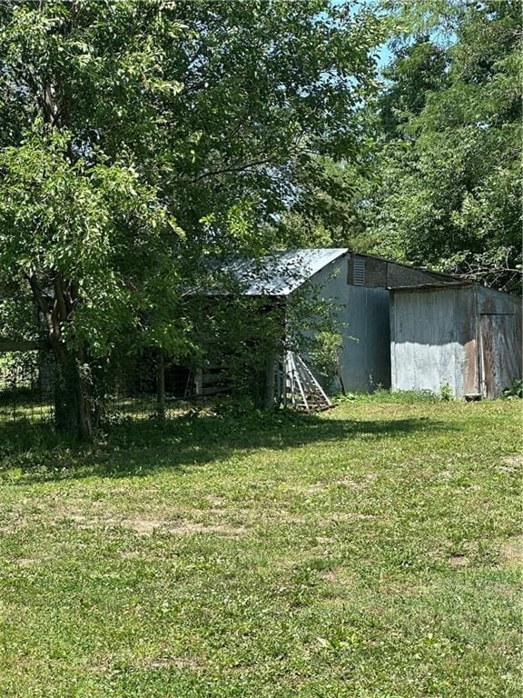 317 Chrissenger St, Burlington Junction, MO 64428 - view of green lawn with an outbuilding