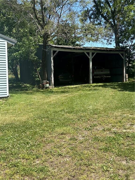 317 Chrissenger St, Burlington Junction, MO 64428 - view of grassy yard featuring a pole building, an outdoor structure, and a detached carport