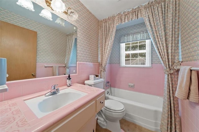 5211 W 79th Ter, Prairie Village, KS 66208 - full bath featuring wallpapered walls, vanity, tile walls, a wainscoted wall, and shower / bath combo with shower curtain