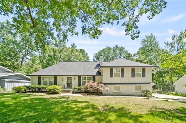 5211 W 79th Ter, Prairie Village, KS 66208 - tri-level home featuring a chimney, a front lawn, board and batten siding, and roof with shingles