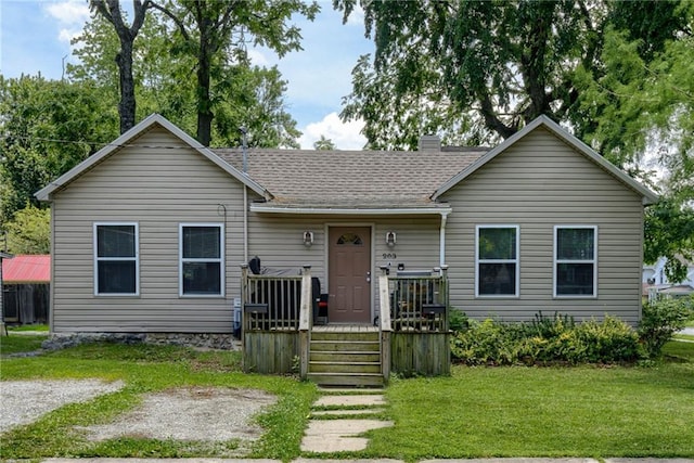 203 E Elm St, Olathe, KS 66061 - view of front facade with a front lawn, a deck, roof with shingles, and a chimney