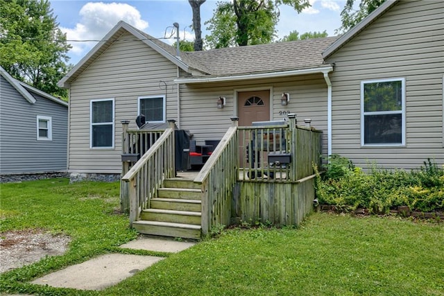 203 E Elm St, Olathe, KS 66061 - view of front facade featuring a deck, a front lawn, and roof with shingles