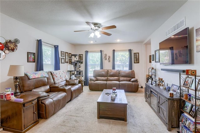 203 E Elm St, Olathe, KS 66061 - living room with ceiling fan, light colored carpet, and a textured ceiling