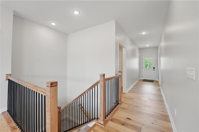 778 Creekmoor Dr, Raymore, MO 64083 - hallway with an upstairs landing, light wood finished floors, and recessed lighting