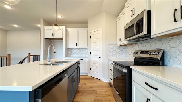 778 Creekmoor Dr, Raymore, MO 64083 - kitchen featuring appliances with stainless steel finishes, light wood-style floors, light countertops, recessed lighting, and white cabinetry