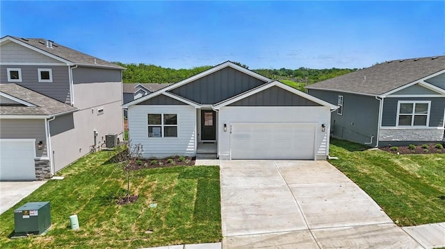 778 Creekmoor Dr, Raymore, MO 64083 - view of front of property with board and batten siding, a garage, concrete driveway, and a front lawn