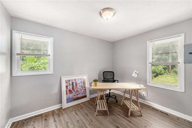 5117 Palmer Dr, Kansas City, MO 64129 - office area featuring plenty of natural light, wood finished floors, and electric panel