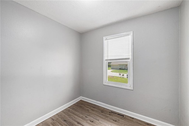 5117 Palmer Dr, Kansas City, MO 64129 - unfurnished room with baseboards and wood finished floors