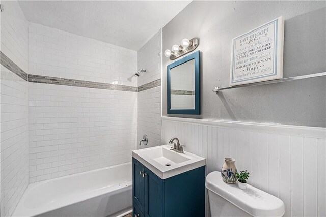 5117 Palmer Dr, Kansas City, MO 64129 - full bath with vanity, bathtub / shower combination, and a wainscoted wall