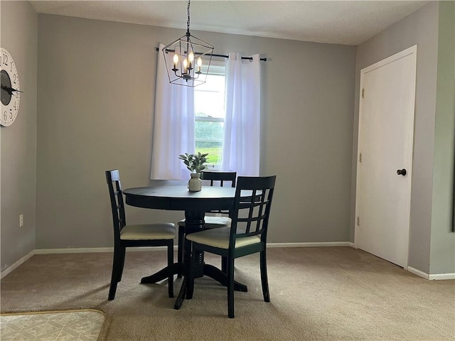 1423 Hickory St, Atchison, KS 66002 - dining area featuring light colored carpet and a chandelier