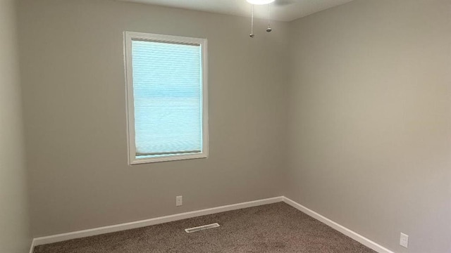 1146 NE 15th Rd, Knob Noster, MO 65336 - unfurnished room featuring dark colored carpet and a ceiling fan