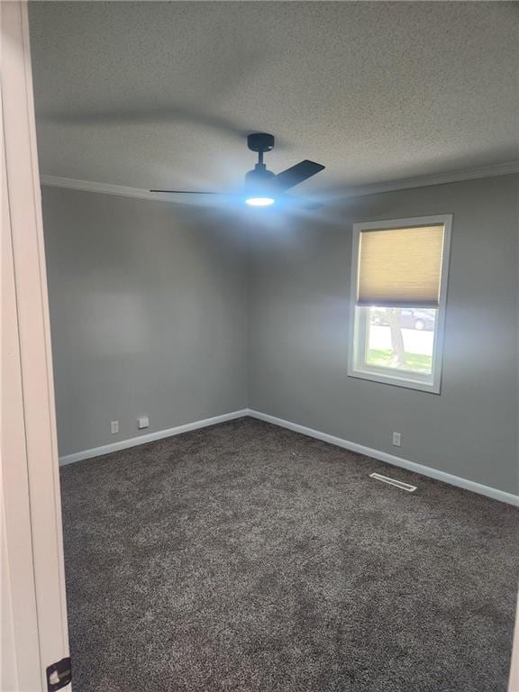 1146 NE 15th Rd, Knob Noster, MO 65336 - spare room featuring a textured ceiling, carpet floors, ornamental molding, and a ceiling fan