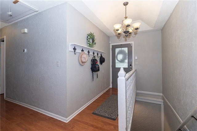 1005 SE Alice St, Blue Springs, MO 64014 - corridor with attic access, wood finished floors, a chandelier, a textured wall, and vaulted ceiling