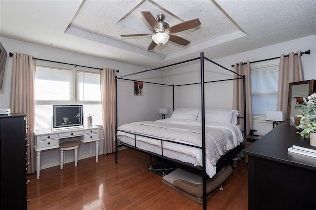 1005 SE Alice St, Blue Springs, MO 64014 - bedroom featuring a raised ceiling, wood finished floors, a textured ceiling, and a ceiling fan