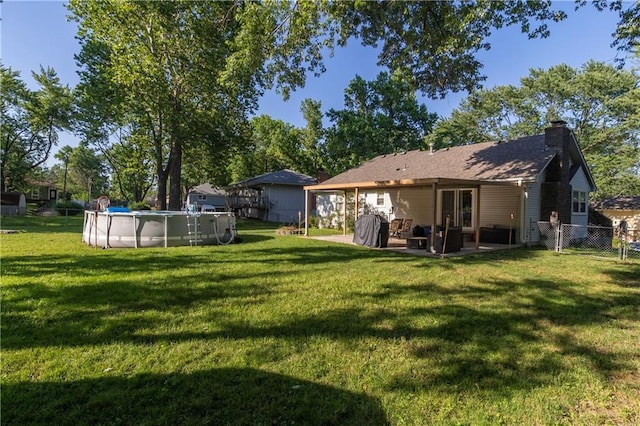 1005 SE Alice St, Blue Springs, MO 64014 - view of yard with an outdoor pool and a patio area