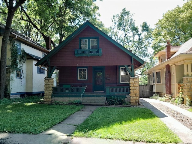 4020 Campbell St, Kansas City, MO 64110 - view of front of home featuring a porch and a front yard