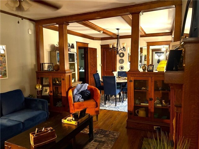 4020 Campbell St, Kansas City, MO 64110 - living area with a ceiling fan, ornamental molding, dark wood-type flooring, a chandelier, and beam ceiling