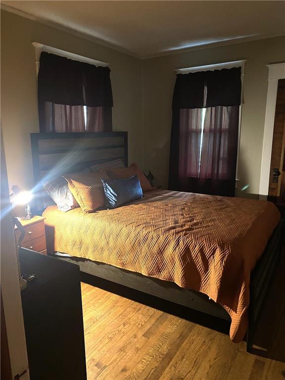 4020 Campbell St, Kansas City, MO 64110 - bedroom featuring wood finished floors