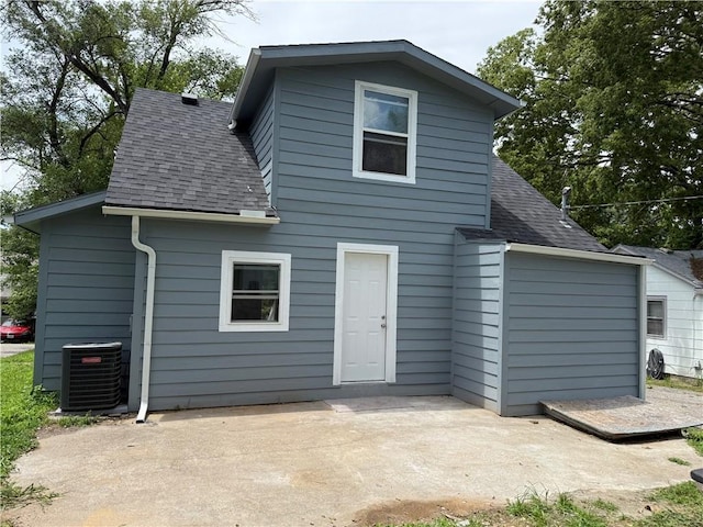 1515 S Home Ave, Independence, MO 64052 - back of property featuring roof with shingles and a patio