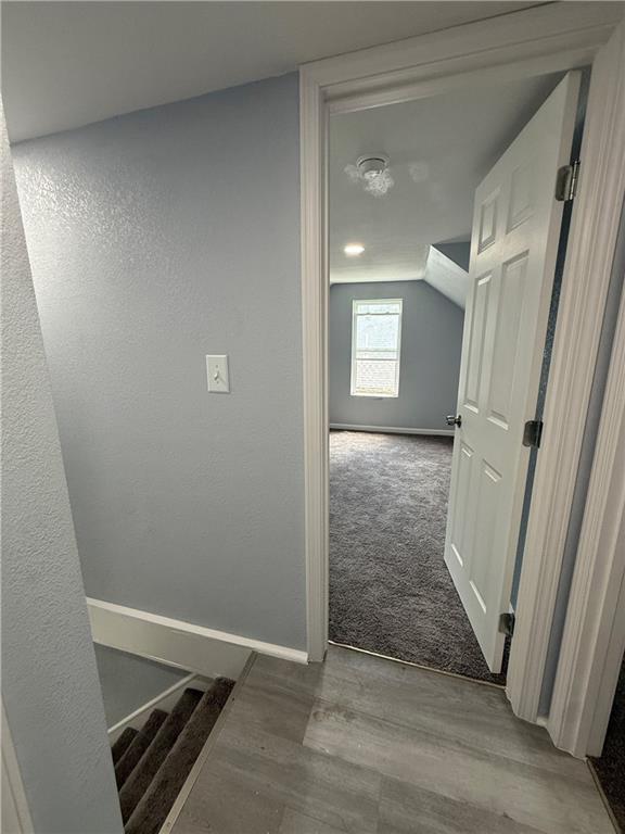 1515 S Home Ave, Independence, MO 64052 - corridor featuring wood finished floors and lofted ceiling