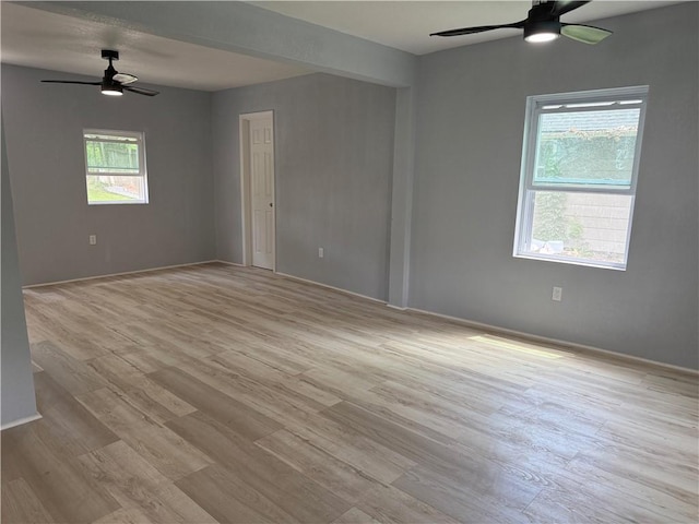 1515 S Home Ave, Independence, MO 64052 - unfurnished room featuring a ceiling fan and light wood-style floors