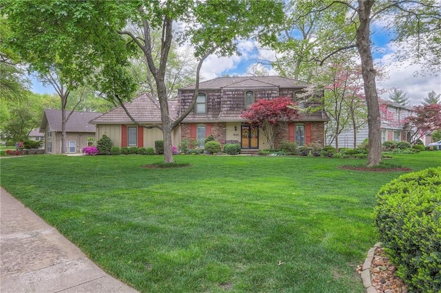 9015 Outlook Dr, Overland Park, KS 66207 - front facade featuring a front yard and brick siding