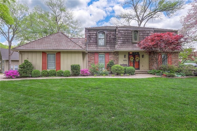 9015 Outlook Dr, Overland Park, KS 66207 - view of property featuring a front yard, brick siding, and board and batten siding