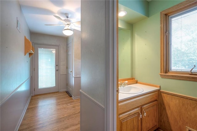 9015 Outlook Dr, Overland Park, KS 66207 - bathroom featuring vanity, wood finished floors, and a ceiling fan