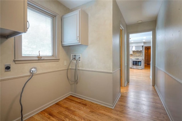 9015 Outlook Dr, Overland Park, KS 66207 - laundry room with hookup for a washing machine, light wood-style floors, electric dryer hookup, and cabinet space