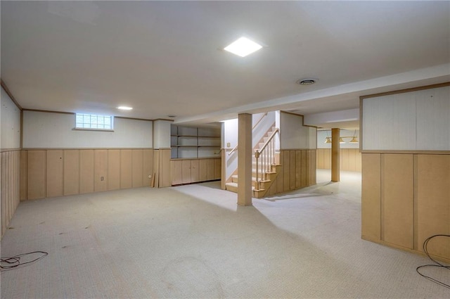 9015 Outlook Dr, Overland Park, KS 66207 - basement featuring carpet flooring, stairway, a wainscoted wall, and wood walls