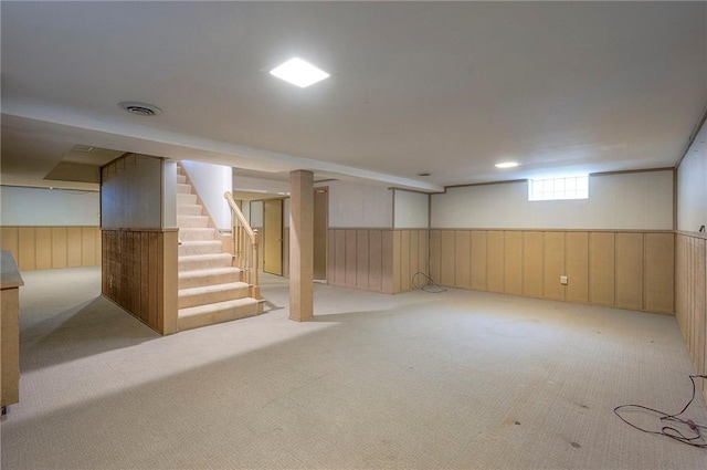 9015 Outlook Dr, Overland Park, KS 66207 - below grade area with carpet, a wainscoted wall, stairway, and wood walls