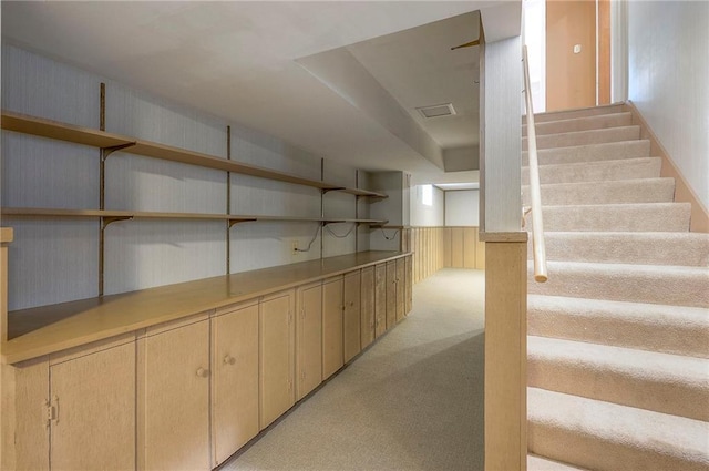 9015 Outlook Dr, Overland Park, KS 66207 - below grade area featuring light colored carpet and stairs