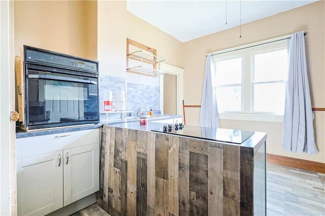 2627 Renick St, Saint Joseph, MO 64507 - kitchen featuring black oven and light wood finished floors