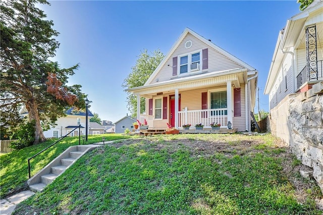 2627 Renick St, Saint Joseph, MO 64507 - bungalow-style home featuring a porch, stairway, and a front yard
