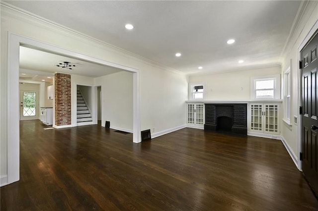 5236 Woodland Ave, Kansas City, MO 64110 - unfurnished living room with stairway, crown molding, wood finished floors, a fireplace, and recessed lighting