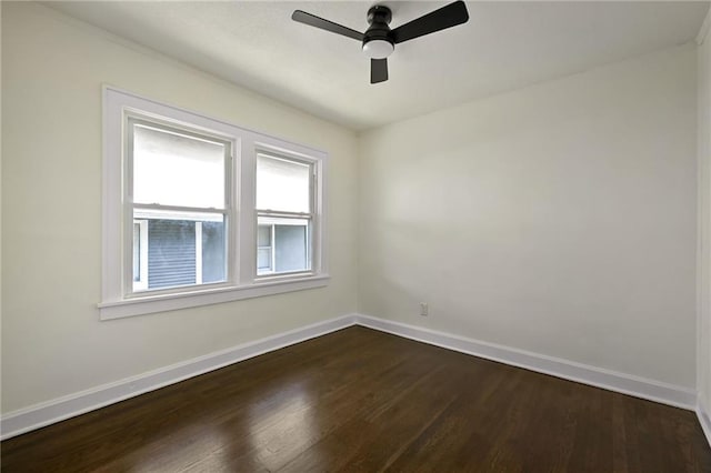 5236 Woodland Ave, Kansas City, MO 64110 - spare room featuring dark wood-type flooring and a ceiling fan