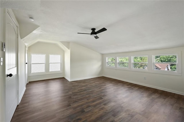 5236 Woodland Ave, Kansas City, MO 64110 - unfurnished room with a ceiling fan, dark wood-type flooring, vaulted ceiling, and a smoke detector
