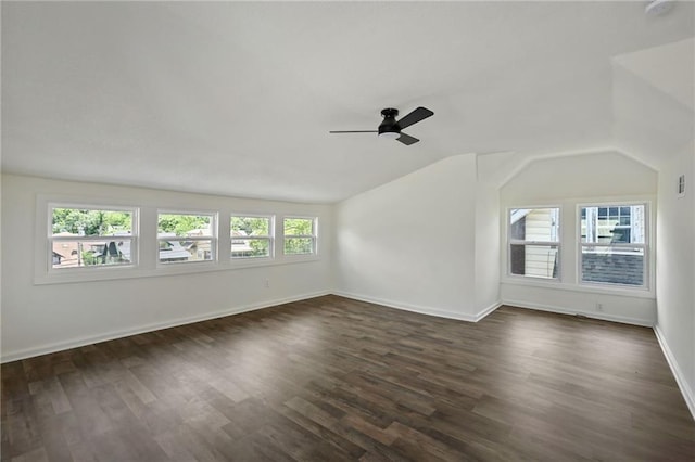 5236 Woodland Ave, Kansas City, MO 64110 - spare room with ceiling fan, dark wood-type flooring, and vaulted ceiling