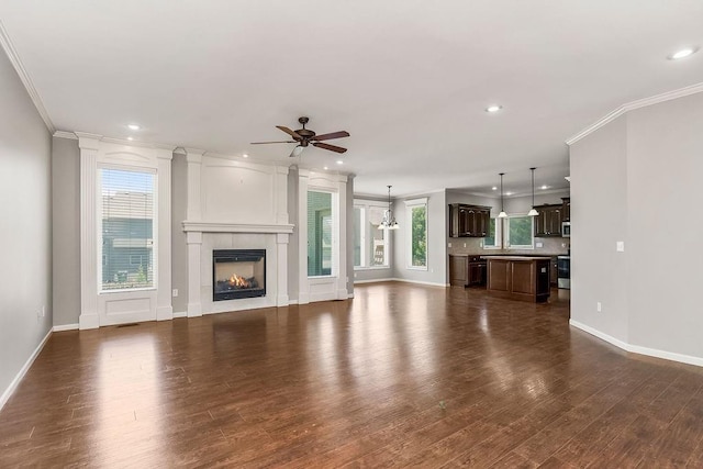 16211 S Locust St, Olathe, KS 66062 - unfurnished living room with ceiling fan, ornamental molding, dark wood-style floors, recessed lighting, and a fireplace