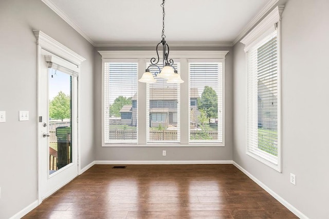 16211 S Locust St, Olathe, KS 66062 - unfurnished dining area featuring plenty of natural light, dark wood-type flooring, ornamental molding, and a chandelier