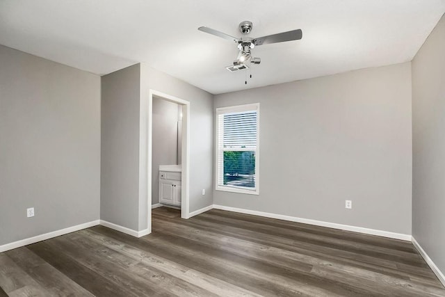 16211 S Locust St, Olathe, KS 66062 - unfurnished bedroom featuring dark wood-style flooring, a ceiling fan, and connected bathroom