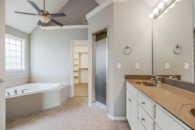 16211 S Locust St, Olathe, KS 66062 - bathroom with a bath, vaulted ceiling, a ceiling fan, double vanity, and tile patterned floors