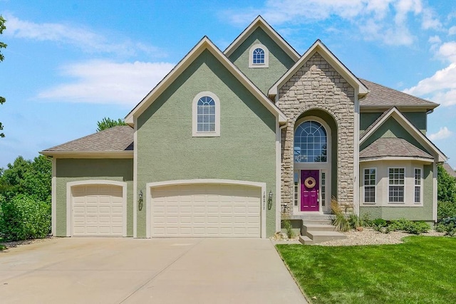 16211 S Locust St, Olathe, KS 66062 - view of front of home featuring stucco siding, stone siding, driveway, a front yard, and an attached garage