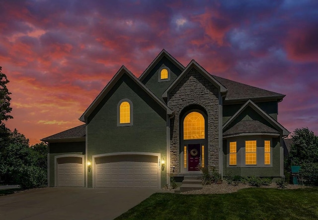 16211 S Locust St, Olathe, KS 66062 - view of front of home with stone siding, a front lawn, driveway, stucco siding, and a garage