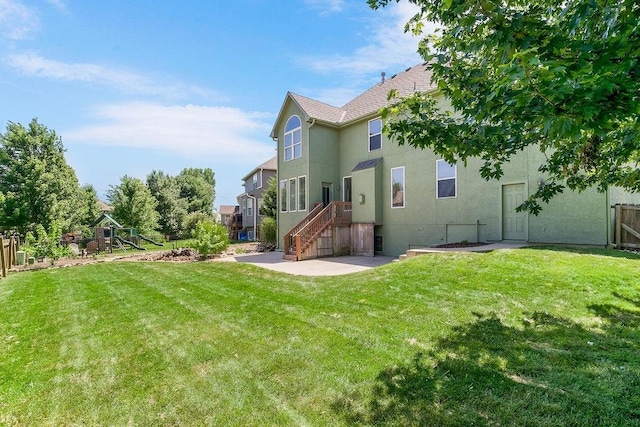 16211 S Locust St, Olathe, KS 66062 - back of property with a playground, stucco siding, and a patio