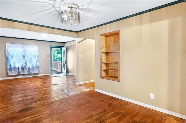 2704 Garland St, Leavenworth, KS 66048 - spare room featuring a chandelier, ornamental molding, and wood finished floors