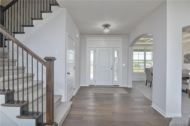 6122 Lewis Dr, Shawnee, KS 66226 - entryway with wood finished floors, arched walkways, and stairway